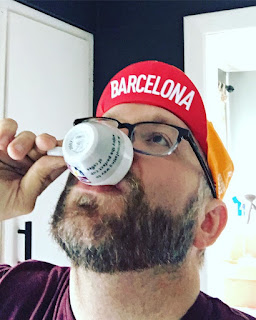Steve Agocs, the KC Coffee Geek sipping an espresso wearing a Barcelona hat